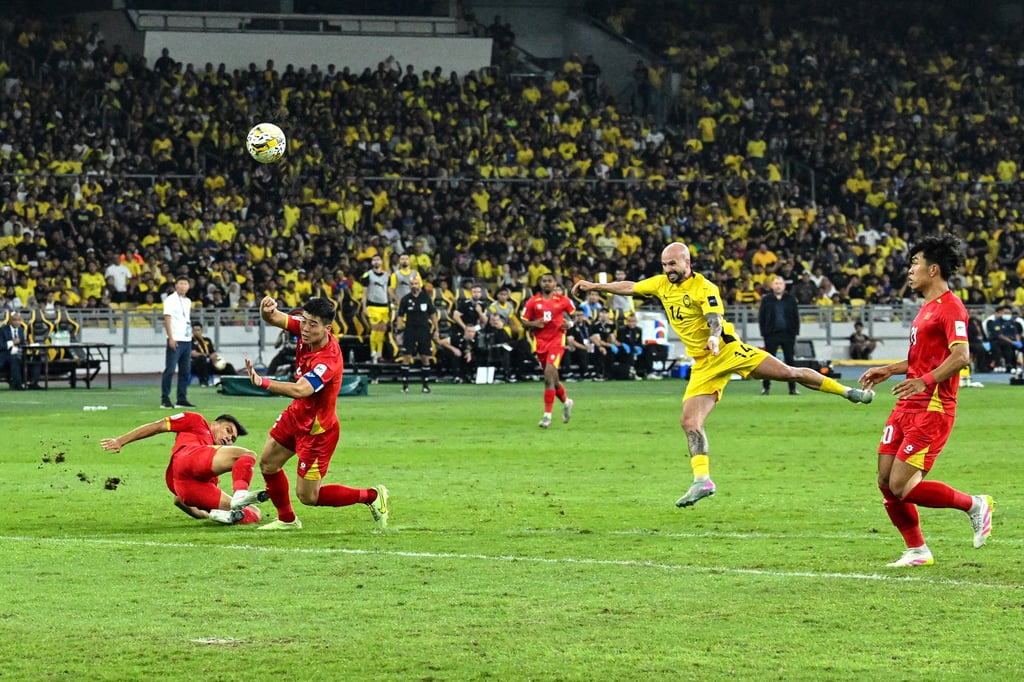 Brazilian-born Joao Figueiredo (second from right) scores a goal during the Asian Cup qualifier match against Vietnam on June 10. Photo: AFP