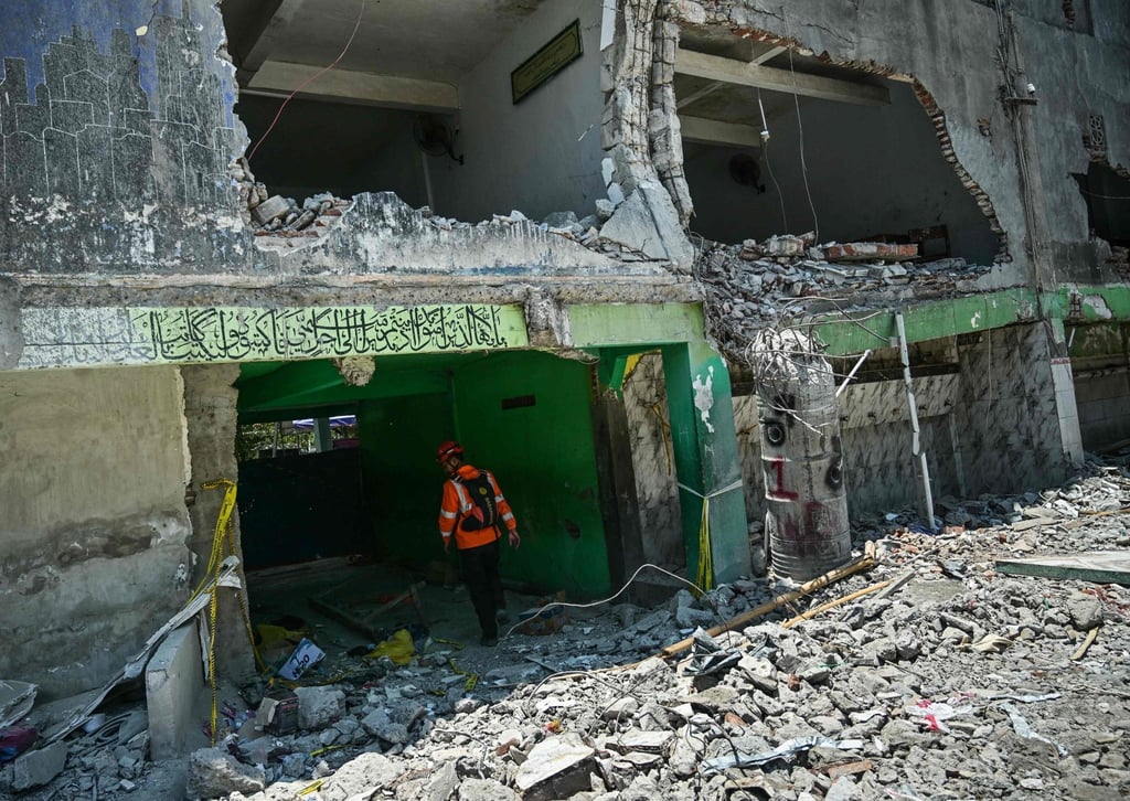 An Indonesian rescuer checks a damaged building at Al Khoziny Islamic Boarding School on Tuesday. Photo: AFP