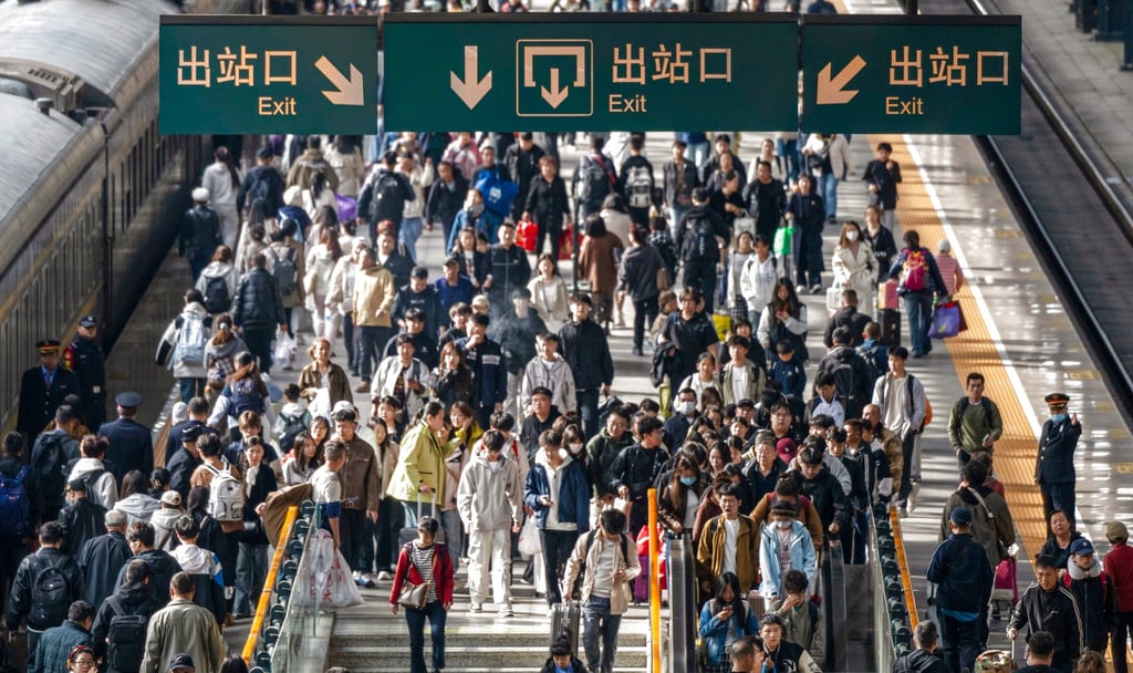 Passengers exit Harbin Railway Station on Tuesday. Authorities said the total number of trips during China’s eight-day holiday was expected to reach a record high of more than 2.4 billion. Photo: Xinhua
