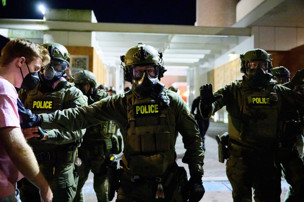 Federal agents keep protesters away from an Immigration and Customs Enforcement facility in downtown Portland, Oregon, on Monday. Photo: AFP Federal agents keep protesters away from an Immigration and Customs Enforcement facility in downtown Portland, Oregon, on Monday. Photo: AFP