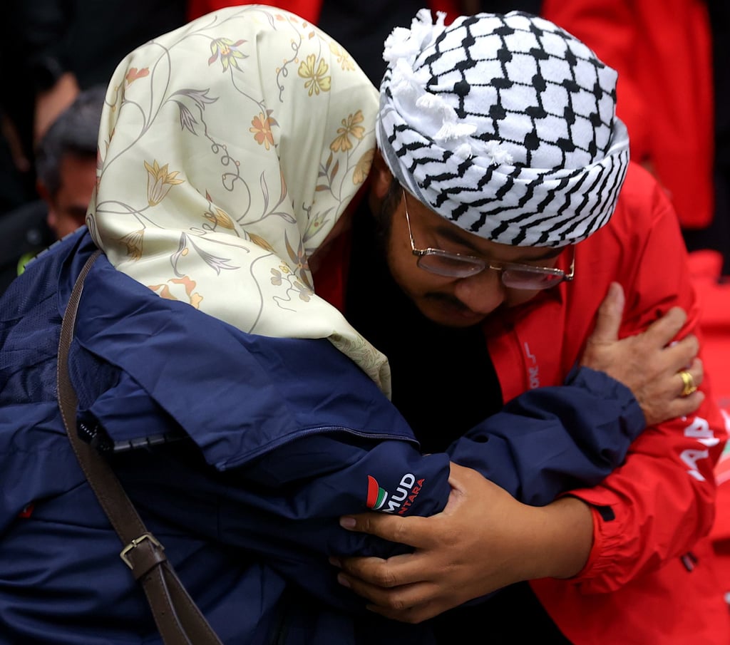 A Malaysian Global Sumud Flotilla activist hugs his mother after his arrival in Kuala Lumpur on Monday. Photo: EPA