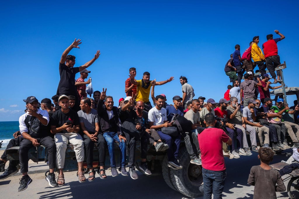 Palestinians make their way along Al-Rashid road towards Gaza City from Nuseirat in the central Gaza Strip on Friday. Photo: AFP