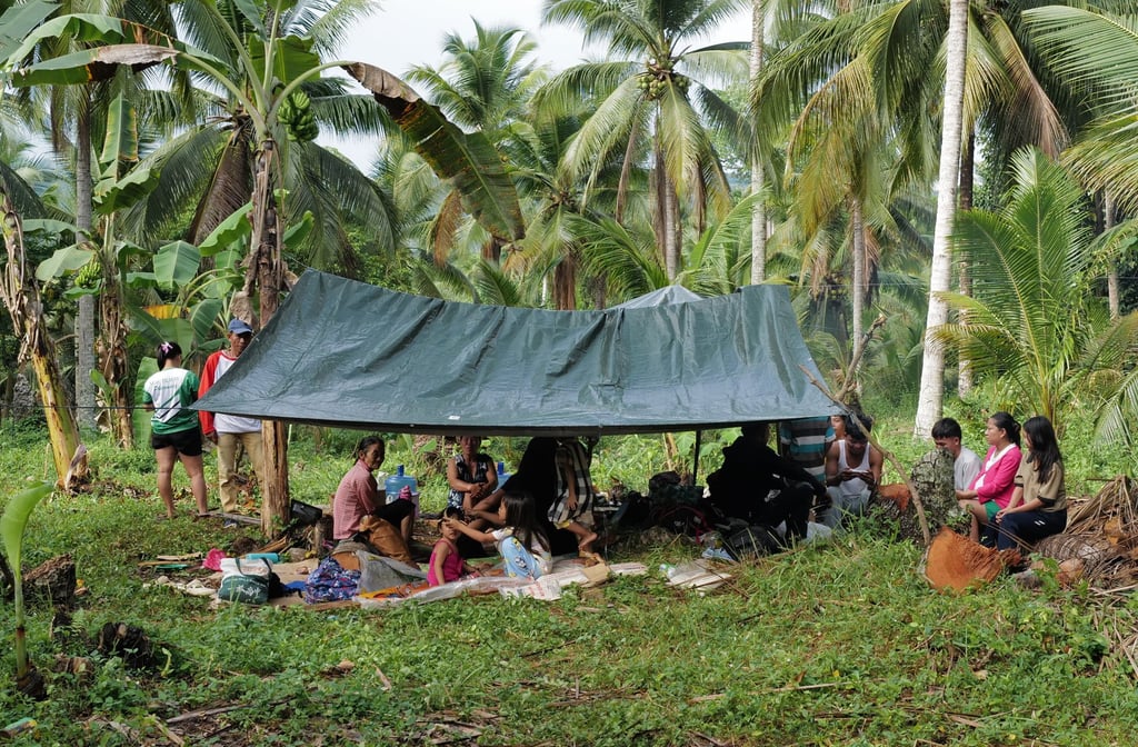 Residents stay under a tent at the earthquake-hit Manay on Saturday. Photo: AP Residents stay under a tent at the earthquake-hit Manay on Saturday. Photo: AP