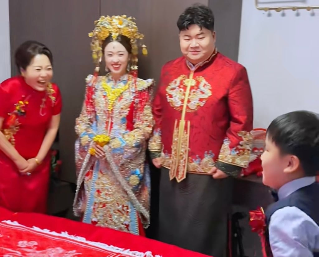 The adults look on as a little boy prepares to perform the ancient ritual. Photo: Douyin/RedNote The adults look on as a little boy prepares to perform the ancient ritual. Photo: Douyin/RedNote