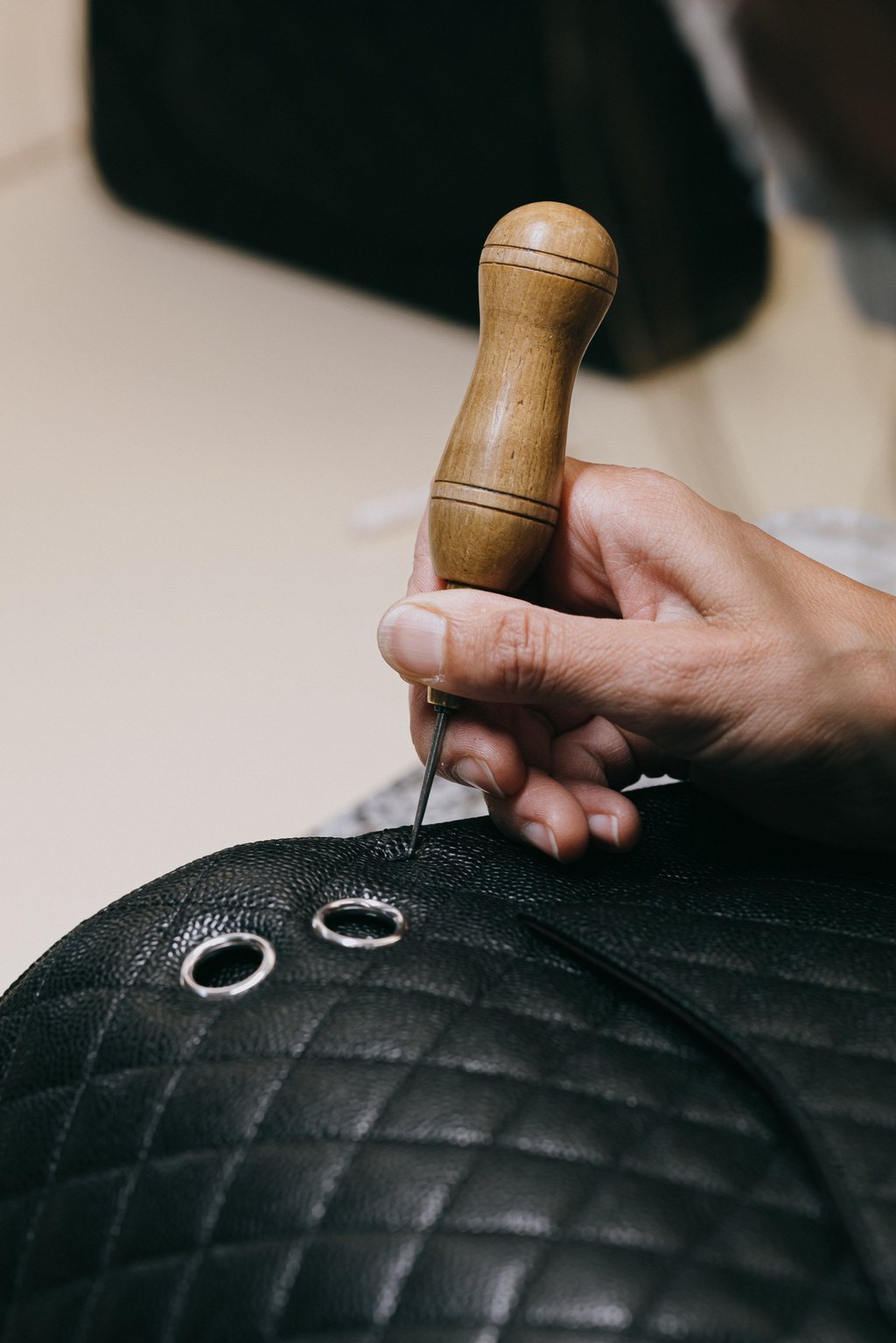 Fine craftsmanship in progress to create a Chanel bag in Caviar leather. Photo: Handout