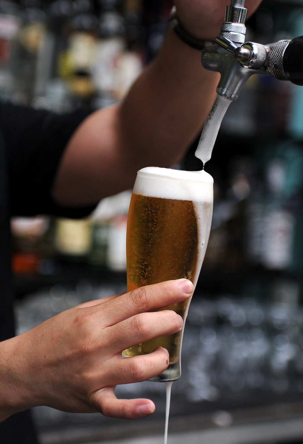 A bartender fills a glass with beer for a customer in Kuala Lumpur’s Bukit Bintang nightlife district. Photo: AFP A bartender fills a glass with beer for a customer in Kuala Lumpur’s Bukit Bintang nightlife district. Photo: AFP