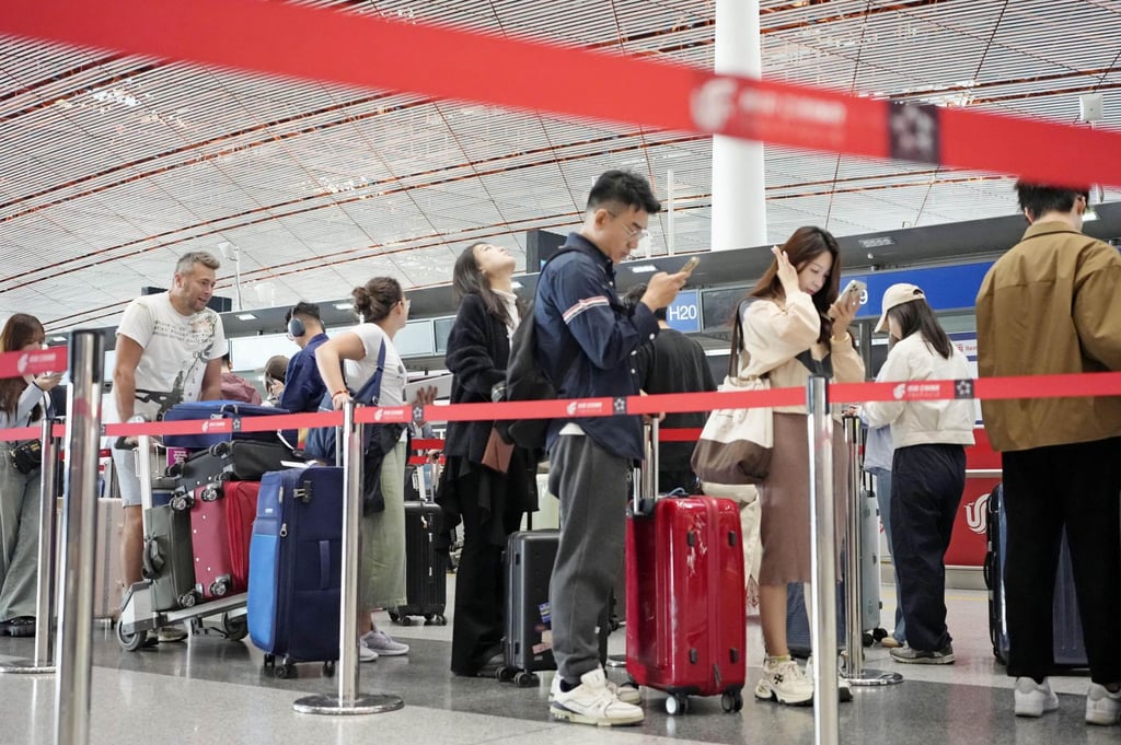 Passengers check in for a flight at Beijing Capital International Airport on October 1. Photo: Kyodo Passengers check in for a flight at Beijing Capital International Airport on October 1. Photo: Kyodo