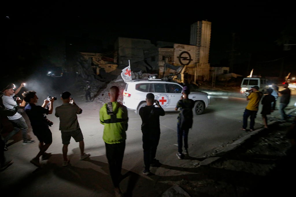 Red Cross vehicles in Gaza City transporting remains of hostages. Photo: EPA