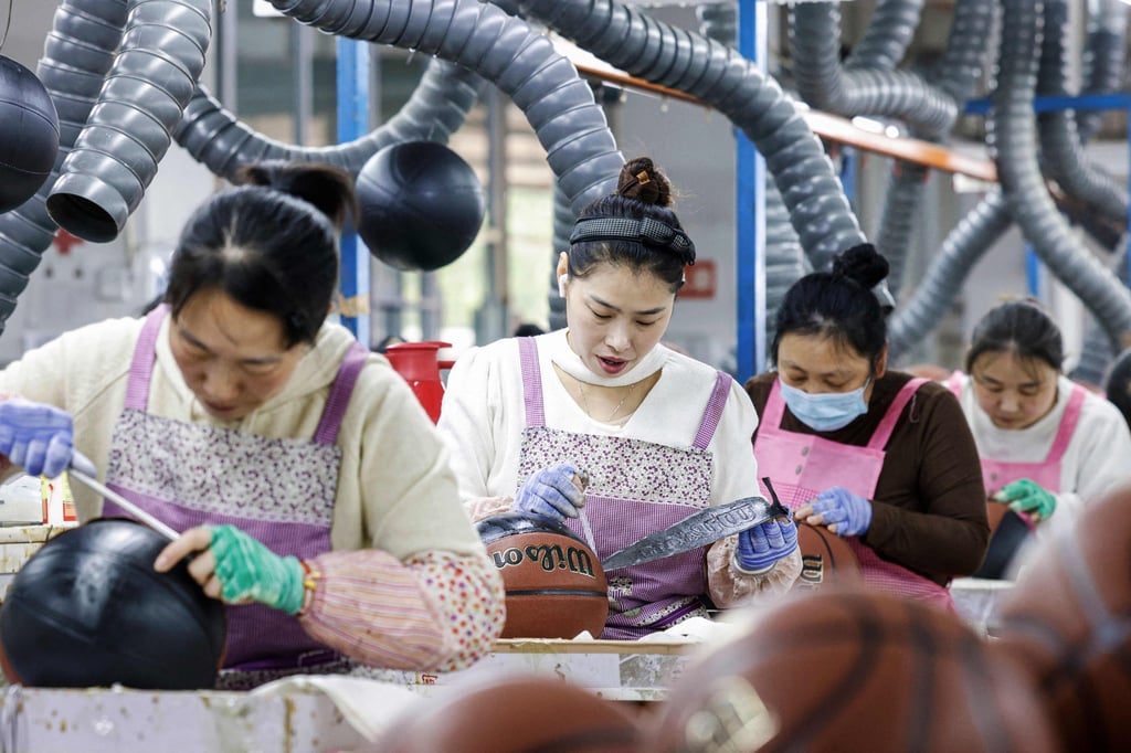 Employees produce basketballs that will be exported to Europe at a factory in Sihong, in eastern China’s Jiangsu province, on March 25. Photo: AFP Employees produce basketballs that will be exported to Europe at a factory in Sihong, in eastern China’s Jiangsu province, on March 25. Photo: AFP