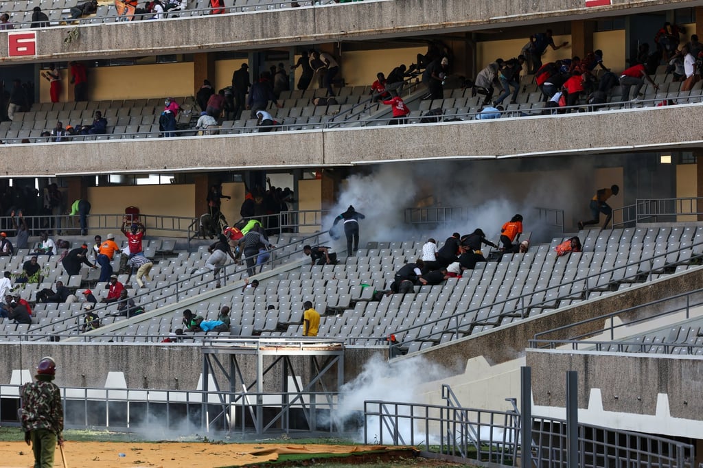 People flee as tear gas is released inside Kasarani Stadium in Nairobi, Kenya, on Thursday. Photo: EPA People flee as tear gas is released inside Kasarani Stadium in Nairobi, Kenya, on Thursday. Photo: EPA