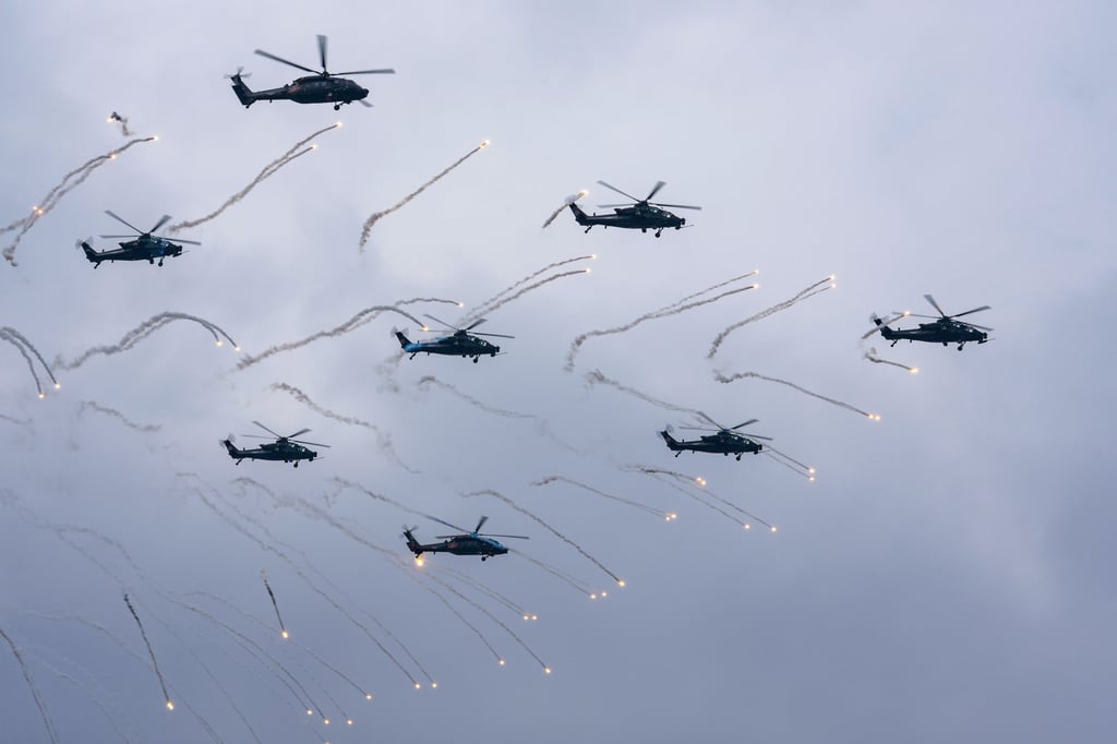 A PLA aerobatic team fires flares during a military air show in Tianjin on Thursday. Photo: EPA A PLA aerobatic team fires flares during a military air show in Tianjin on Thursday. Photo: EPA