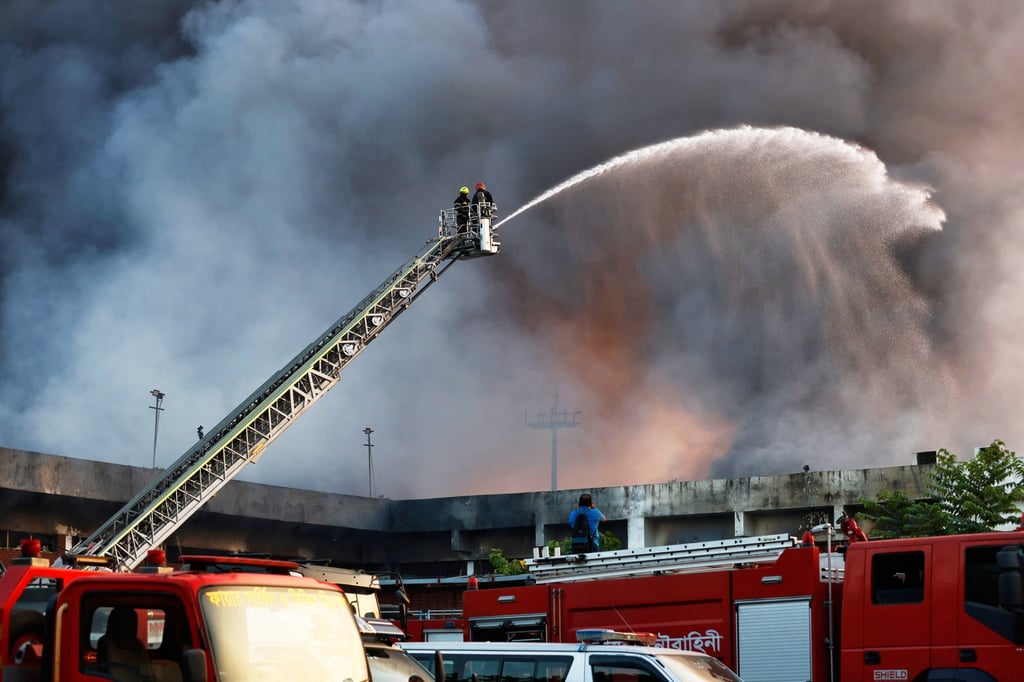 Firefighters try to contain a fire in the cargo area of Hazrat Shahjalal International Airport in Dhaka, Bangladesh, on Saturday. Photo: AP Firefighters try to contain a fire in the cargo area of Hazrat Shahjalal International Airport in Dhaka, Bangladesh, on Saturday. Photo: AP