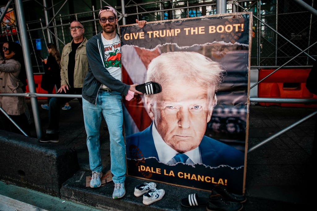 A person hits with a sandal an image of US President Donald Trump, during a “No Kings” protest against Trump’s policies, in Times Square in New York City on Saturday. Photo: Reuters A person hits with a sandal an image of US President Donald Trump, during a “No Kings” protest against Trump’s policies, in Times Square in New York City on Saturday. Photo: Reuters