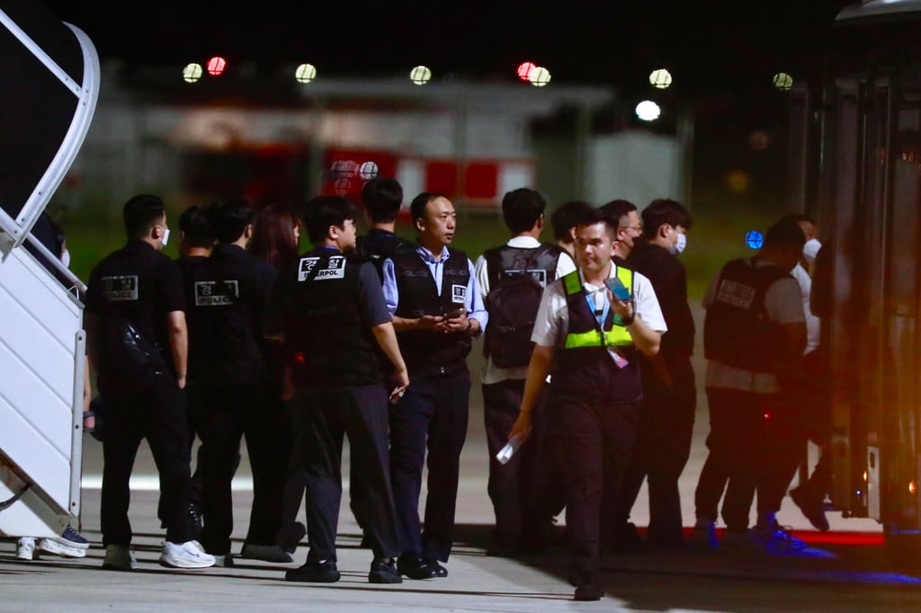 South Korean police officers walk at Techo International Airport near Phnom Penh on Friday night. Photo: EPA South Korean police officers walk at Techo International Airport near Phnom Penh on Friday night. Photo: EPA