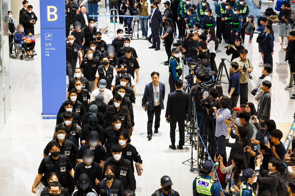 South Koreans detained in Cambodia over their alleged involvement in online scams arrive at Incheon International Airport in South Korea on Saturday. Photo: Yonhap/EPA