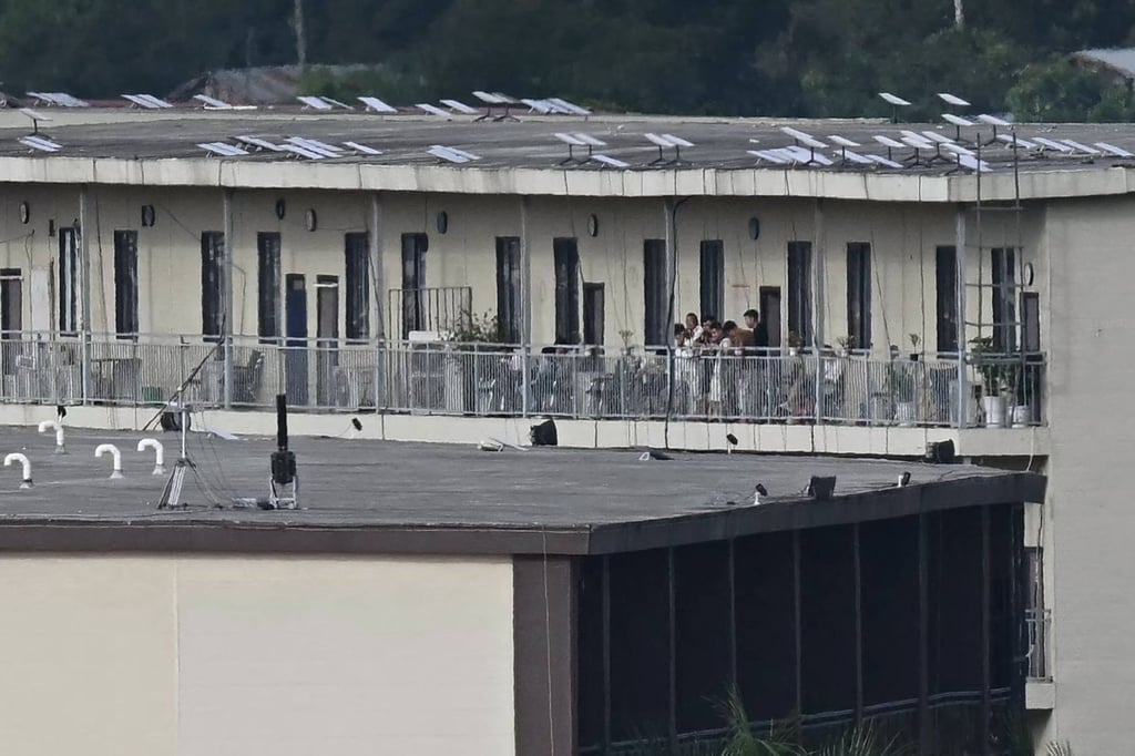 A view of the KK Park complex people on a balcony of a building with what appears to be Starlink satellite dishes on its on September 17. Photo: AFP A view of the KK Park complex people on a balcony of a building with what appears to be Starlink satellite dishes on its on September 17. Photo: AFP
