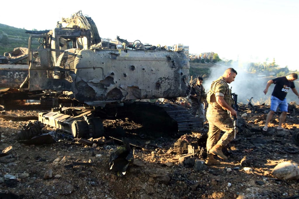 Lebanese soldiers walk next to a destroyed digger following an overnight Israeli strike in southern Lebanon earlier this month. Photo: AFP Lebanese soldiers walk next to a destroyed digger following an overnight Israeli strike in southern Lebanon earlier this month. Photo: AFP