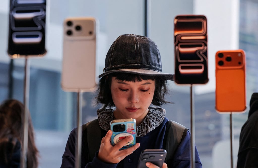A woman uses her smartphone inside the Apple Store in Beijing’s Sanlitun area, as the new iPhone 17 series handsets go on sale on September 19, 2025. Photo: Reuters A woman uses her smartphone inside the Apple Store in Beijing’s Sanlitun area, as the new iPhone 17 series handsets go on sale on September 19, 2025. Photo: Reuters