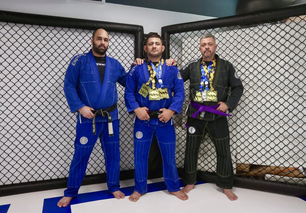 Hollis (right) stands with Espada Studio co-founders Nosherwan Khanzada (left) and Rodrigo Caporal at the BJJ gym in Sheung Wan. Photo: Jonathan Wong
