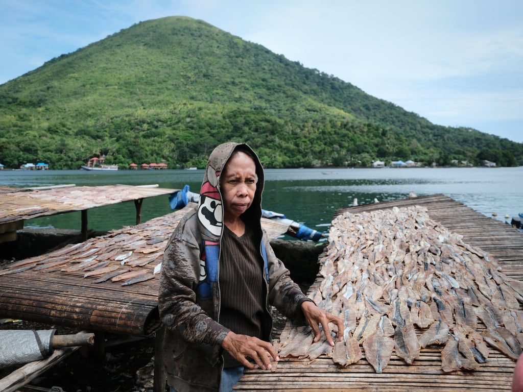 A woman lays out fish to dry in Banda Neira’s market. Photo: Chan Kit Yeng