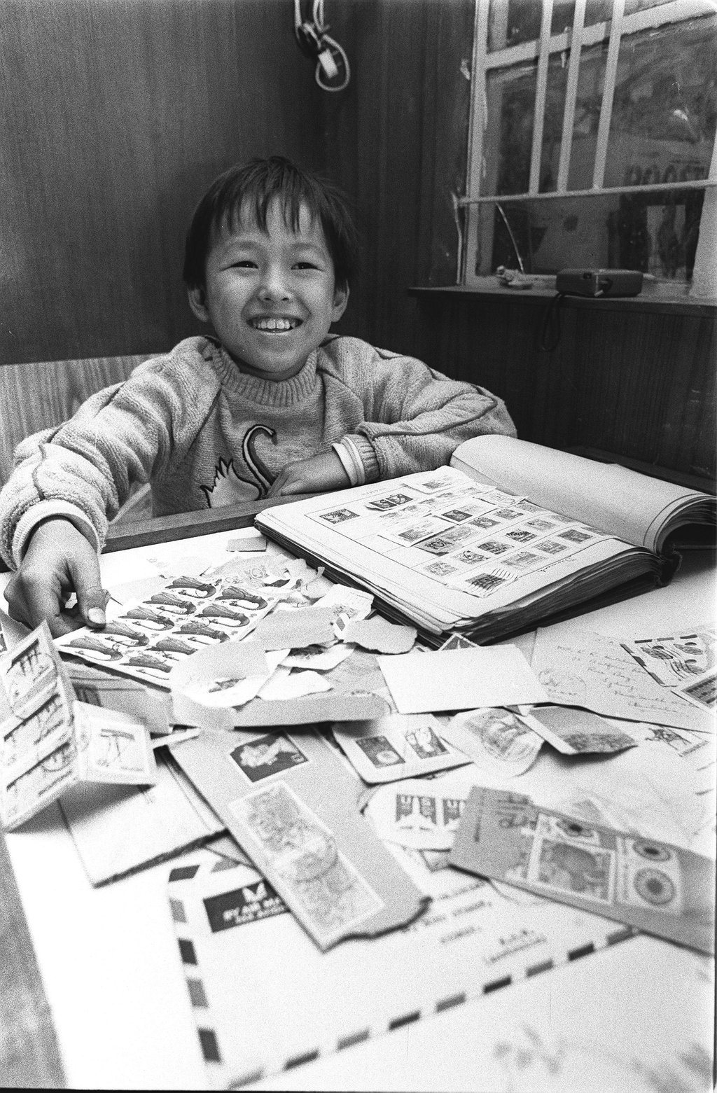 Chung Siu-hong gets an early Christmas present in 1983. Three days earlier, the 10-year-old had lost his stamp collection in a squatter area blaze in Cha Kwo Ling. Learning of his plight, Robin Hutcheon, the editor of the South China Morning Post, sent him a 50-year-old album containing stamps from all over the world. Photo: SCMP Archives Chung Siu-hong gets an early Christmas present in 1983. Three days earlier, the 10-year-old had lost his stamp collection in a squatter area blaze in Cha Kwo Ling. Learning of his plight, Robin Hutcheon, the editor of the South China Morning Post, sent him a 50-year-old album containing stamps from all over the world. Photo: SCMP Archives