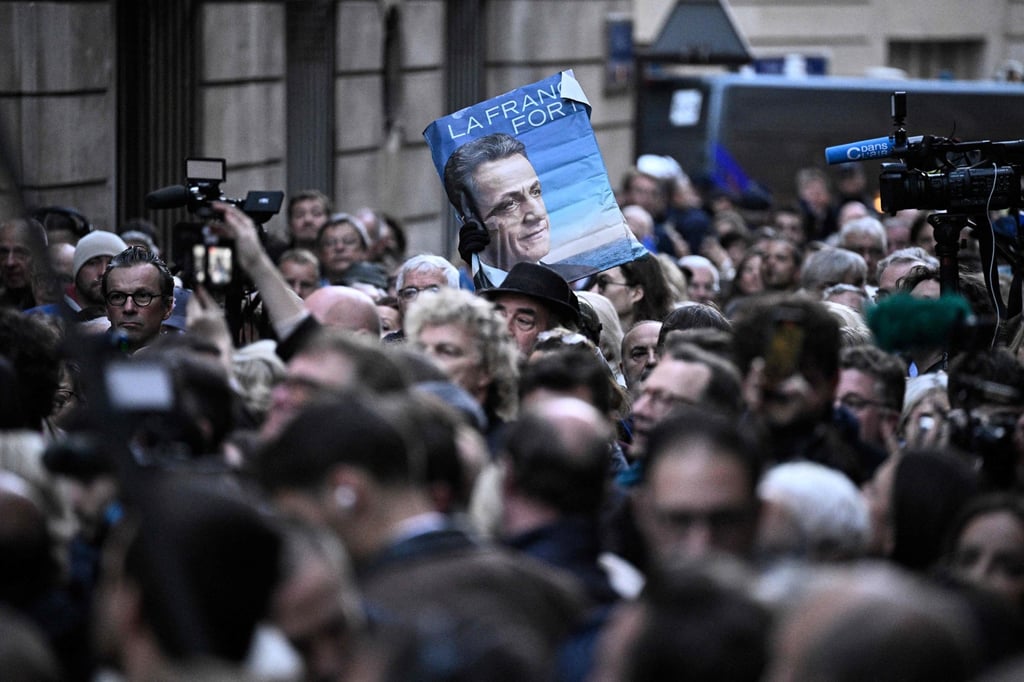 Supporters of Nicolas Sarkozy gather outside his residence. Photo: AFP