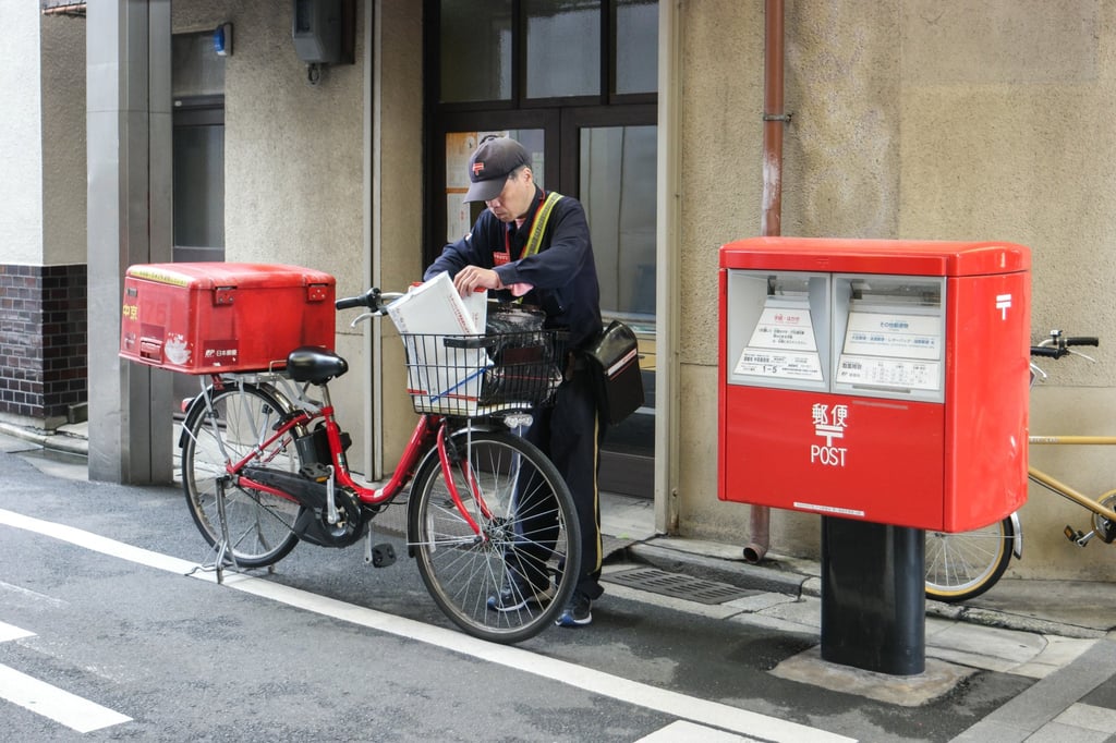 A Japanese postman sorts mail near a postbox. Japan issued guidelines in 2022 covering human rights in the workplace. Photo: Shutterstock A Japanese postman sorts mail near a postbox. Japan issued guidelines in 2022 covering human rights in the workplace. Photo: Shutterstock