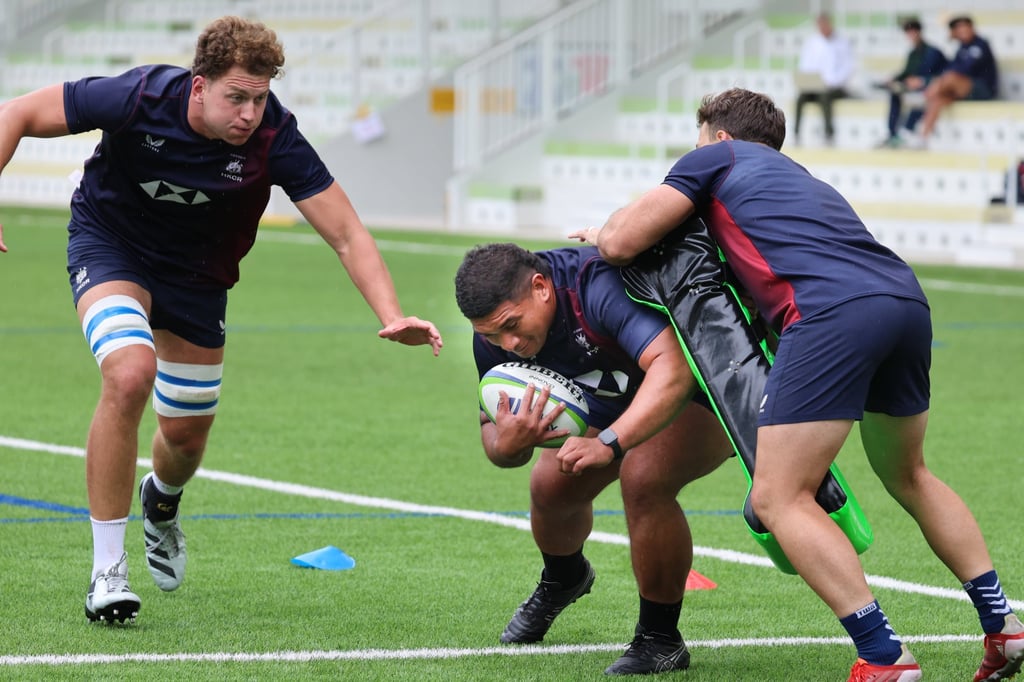 Hong Kong’s Sunia Fameitau (centre), followed by Max Murphy, takes the ball into contact during a training session. Photo: Dickson Lee