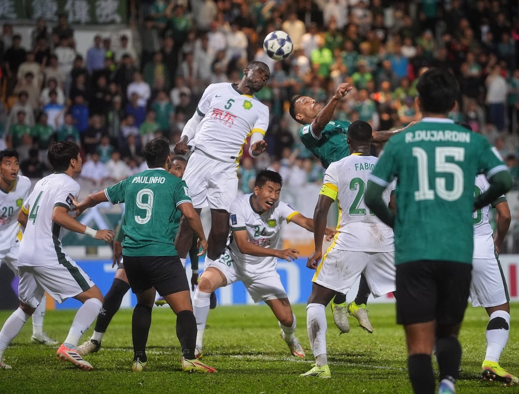 Michael Ngadeu, here leaping to clear the danger, netted Beijing’s second goal. Photo: Elson Li Michael Ngadeu, here leaping to clear the danger, netted Beijing’s second goal. Photo: Elson Li