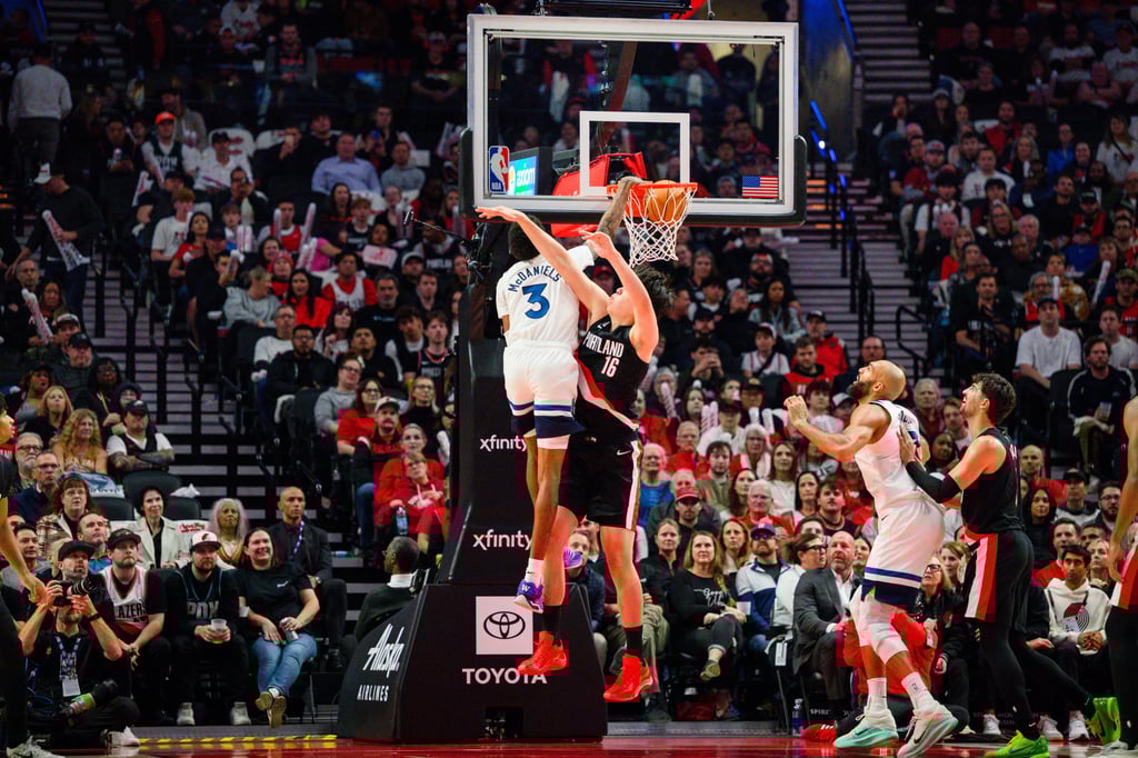 Minnesota Timberwolves forward Jaden McDaniels dunks over Yang Hansen. Photo: AP Minnesota Timberwolves forward Jaden McDaniels dunks over Yang Hansen. Photo: AP