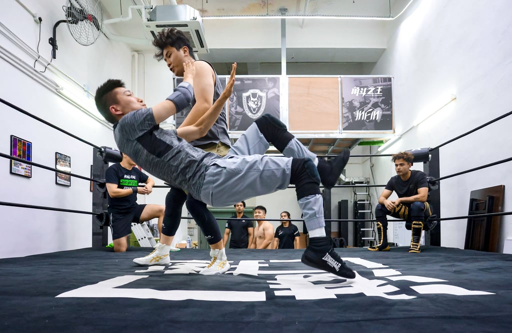 Wrestlers practise a move at a Hong Kong Wrestling Federation Pro Wrestling training session. A leader of the group talks about an upcoming event and why he wants people “to enjoy the experience”. Photo: Jonathan Wong
