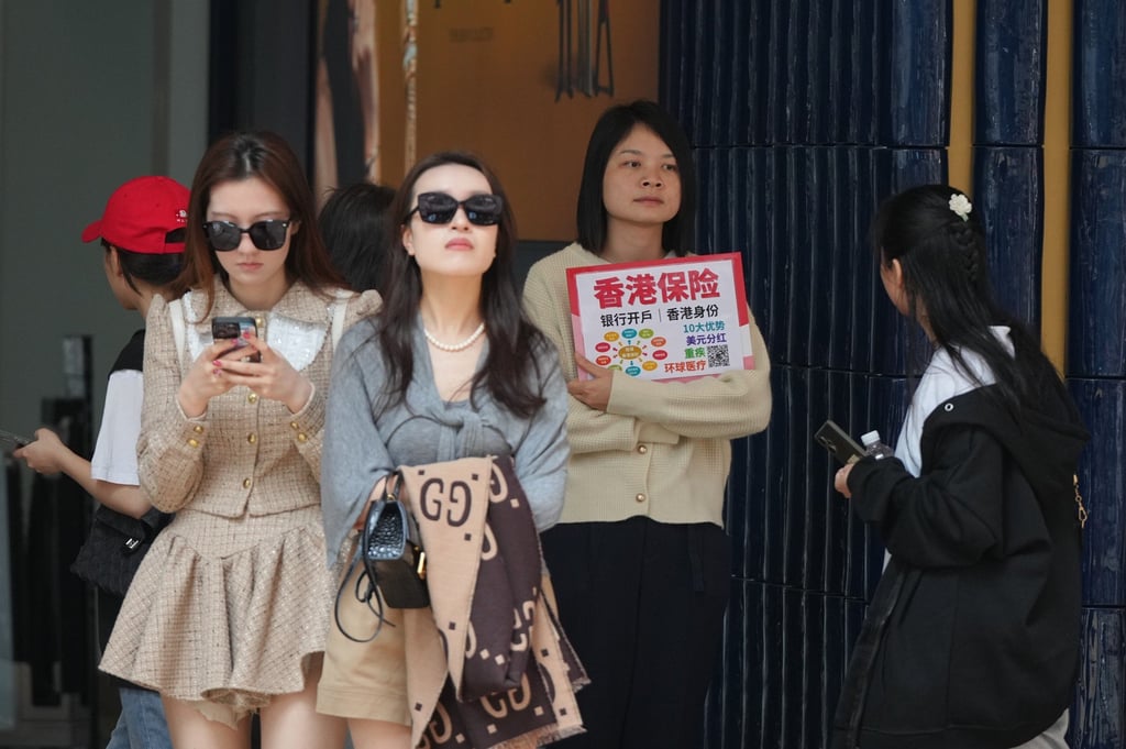 Insurance sales agents approach mainland tourists in Canton Road, Tsim Sha Tsui. Photo: Eugene Lee Insurance sales agents approach mainland tourists in Canton Road, Tsim Sha Tsui. Photo: Eugene Lee