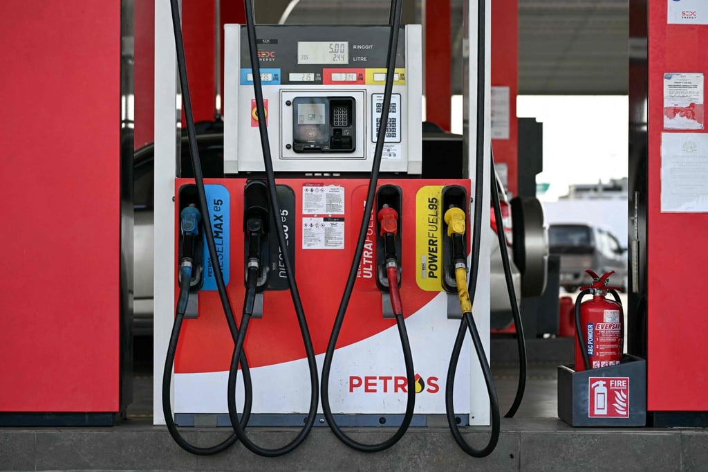 Fuel pump nozzles are seen at a petrol station in Sarawak, Malaysia. Photo: AFP