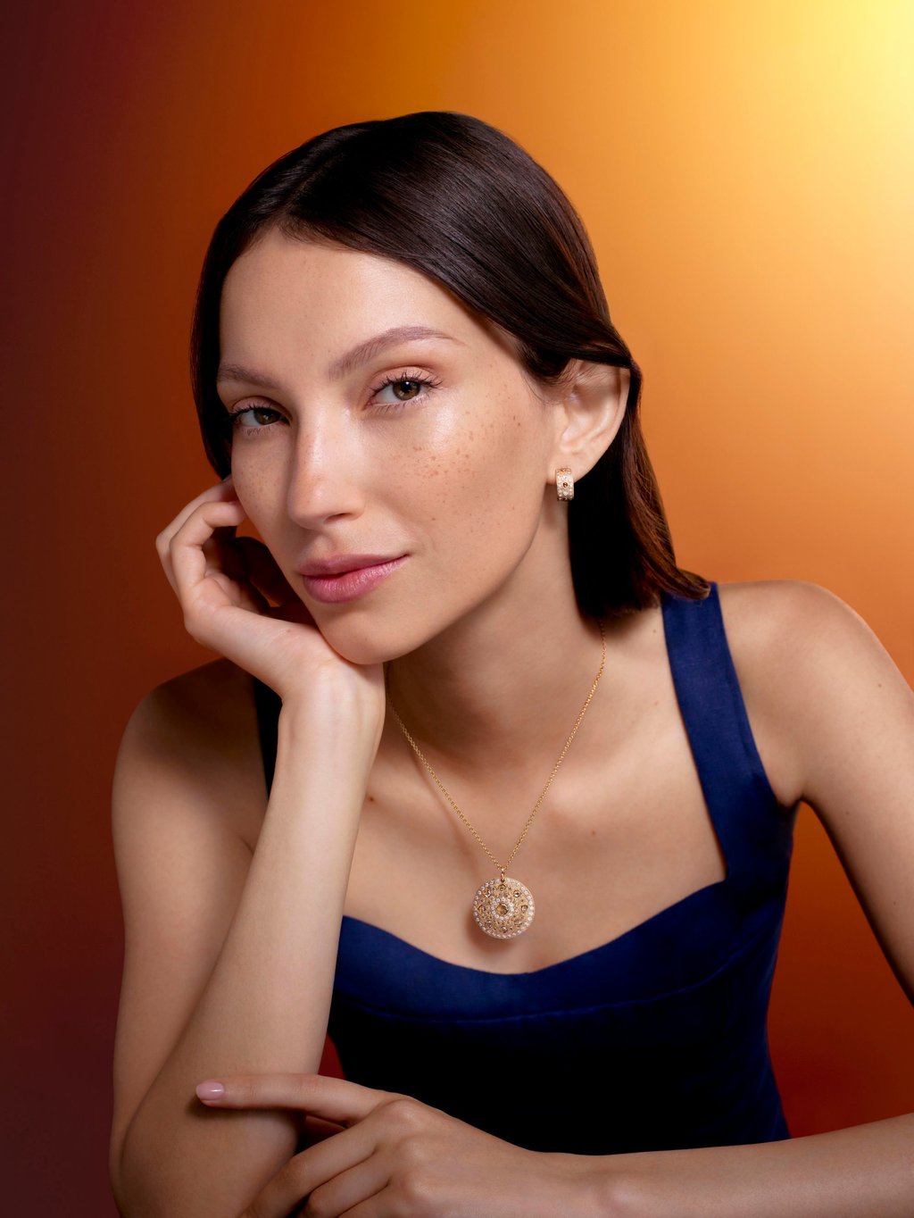 De Beers Talisman medal and small hoop earrings. Photo: Handout