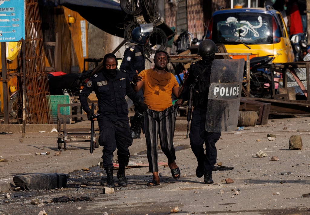 Security forces detain a supporter of Tchiroma, in Douala, Cameroon on Sunday. Photo: Reuters
