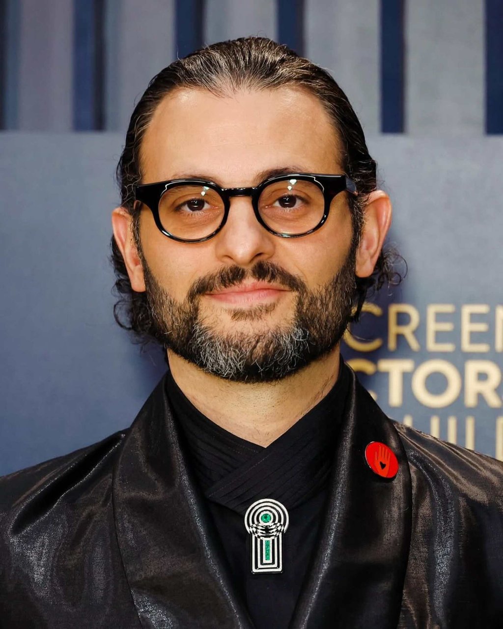 Arian Moayed wearing an Artists For Ceasefire pin in 2024. Photo: @arianmoayed/Instagram