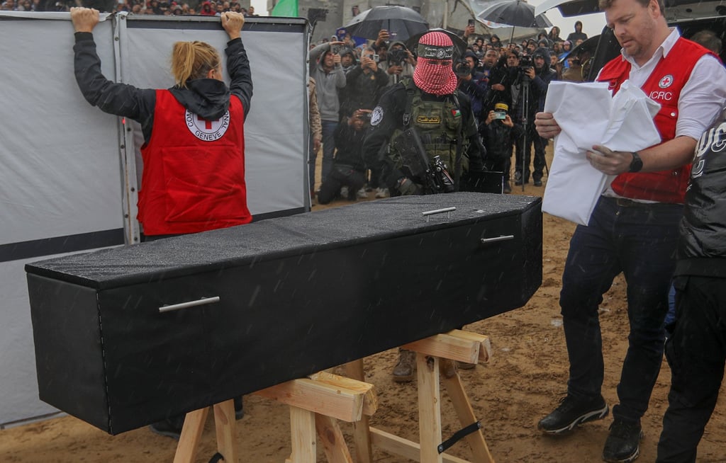 Members of the Red Cross inspect a coffin during the handover of the bodies of four Israeli hostages by Hamas in Khan Younis on February 20. Photo: dpa