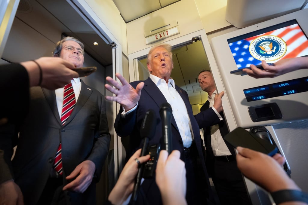 US President Donald Trump speaking to reporters aboard Air Force One while traveling to Tokyo, Japan. Photo: AP US President Donald Trump speaking to reporters aboard Air Force One while traveling to Tokyo, Japan. Photo: AP