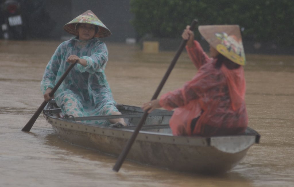 Women paddle a boat on a flooded street in Hue, Vietnam, on Tuesday. Photo: VNA/AP Women paddle a boat on a flooded street in Hue, Vietnam, on Tuesday. Photo: VNA/AP