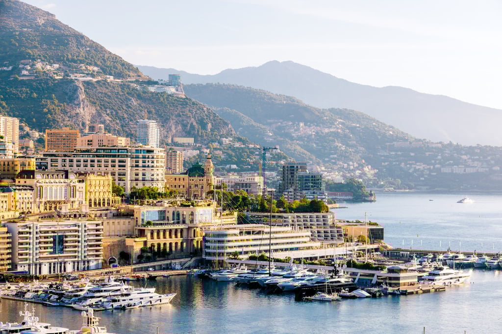 Monte Carlo and Port Hercule harbour surrounded by mountains, Monaco. Photo: Getty Images
