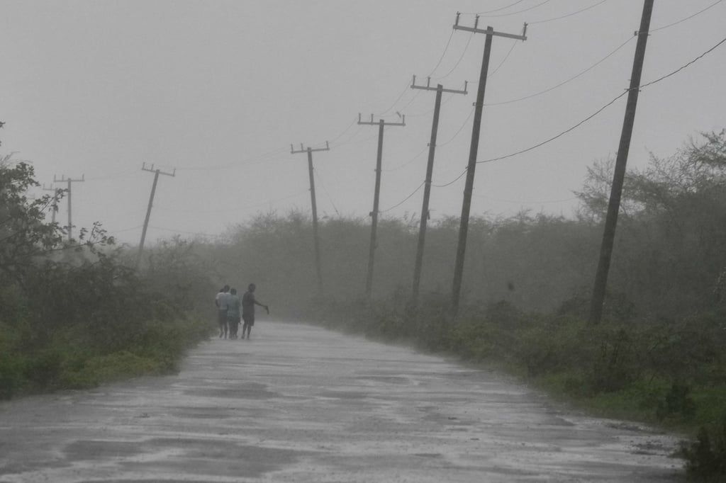People walk along a road during the passing of Hurricane Melissa in Rocky Point, Jamaica. Photo: AP People walk along a road during the passing of Hurricane Melissa in Rocky Point, Jamaica. Photo: AP