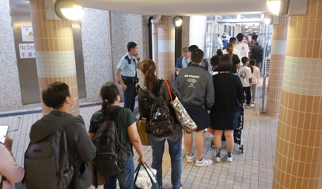 Police check the identity cards of residents at Wang Sum House. Photo: Handout