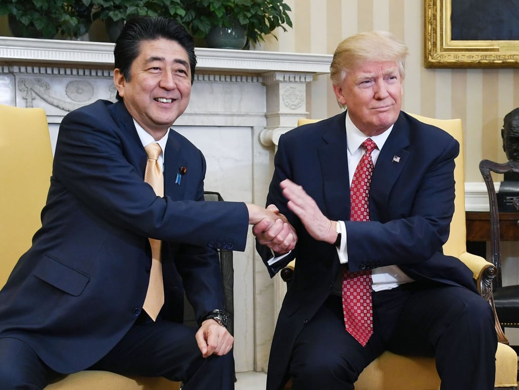 Japanese Prime Minister Shinzo Abe (left) shakes hands with Trump at the White House in February 2017. Photo: Kyodo Japanese Prime Minister Shinzo Abe (left) shakes hands with Trump at the White House in February 2017. Photo: Kyodo