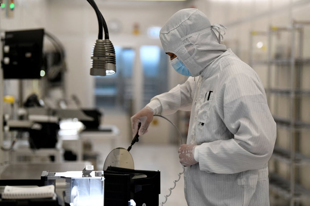 An employee holds a wafer at a Nexperia production facility in Hamburg, Germany. Photo: Reuters