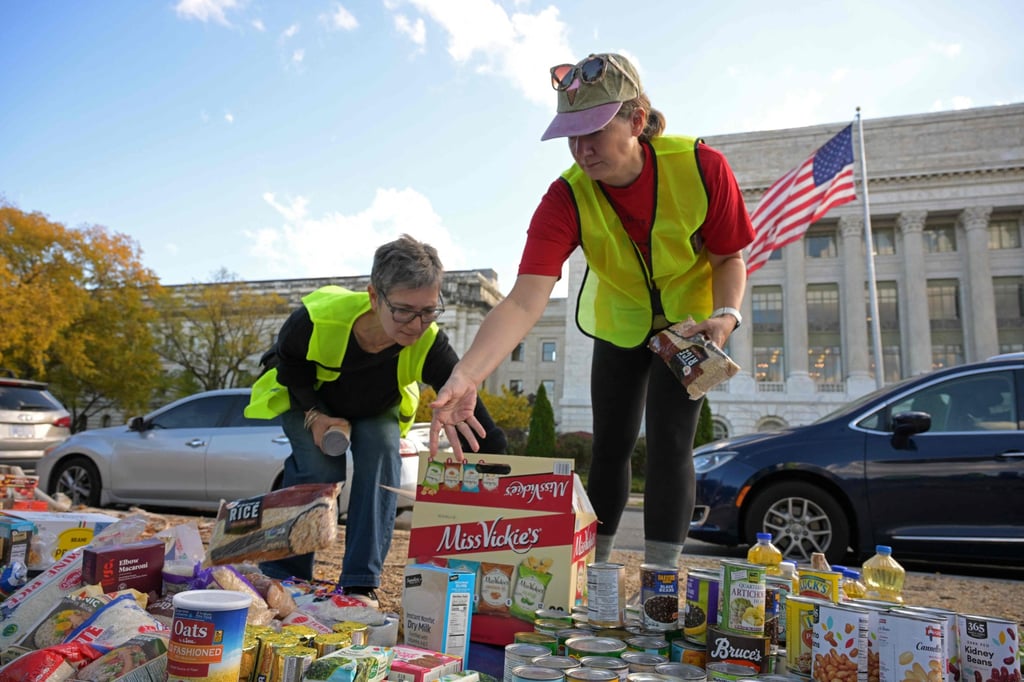Volunteers place groceries during the People’s Pantry Food drive to replenish food banks ahead of SNAP lapse at the USDA Headquarters in Washington on Thursday. Photo: AFP Volunteers place groceries during the People’s Pantry Food drive to replenish food banks ahead of SNAP lapse at the USDA Headquarters in Washington on Thursday. Photo: AFP