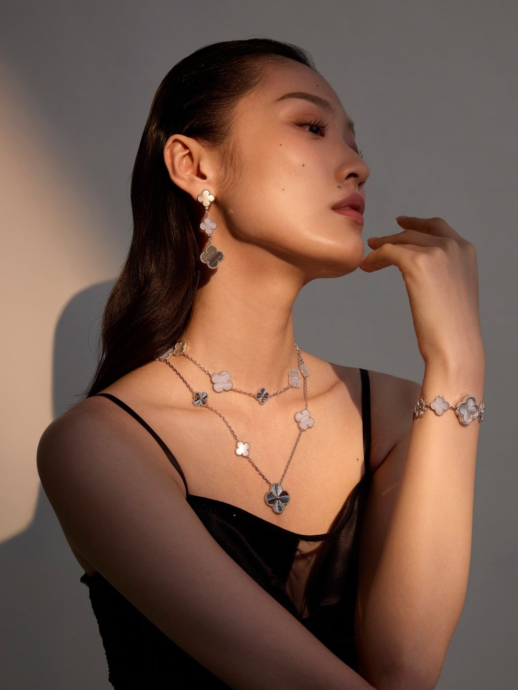 Necklace, watch and earring: Van Cleef & Arpels. Dress: Ports 1961