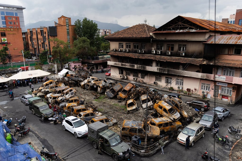 Court personnel gather under makeshift tents beside heaps of charred vehicles at the torched Supreme Court premises in Kathmandu on September 14. Photo: AFP Court personnel gather under makeshift tents beside heaps of charred vehicles at the torched Supreme Court premises in Kathmandu on September 14. Photo: AFP