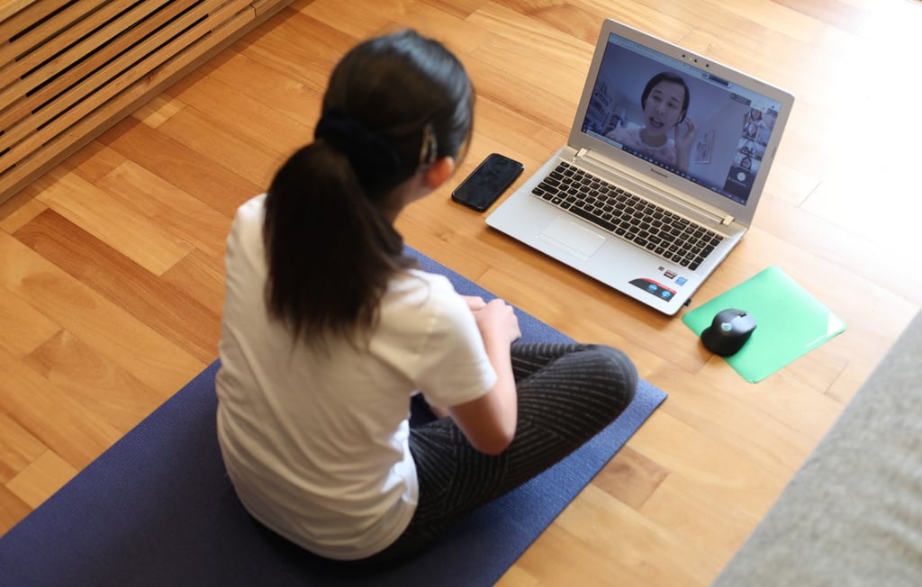 A girl attends an online physical education class at her home in Tai Koo during the Covid-19 pandemic in March 2020. Photo: Xiaomei Chen A girl attends an online physical education class at her home in Tai Koo during the Covid-19 pandemic in March 2020. Photo: Xiaomei Chen