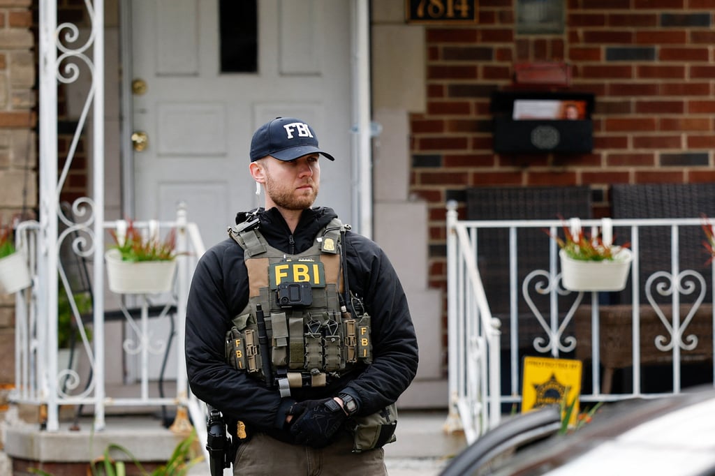 A member of the FBI Joint Terrorism Task Force stands watch as law enforcement officers search a home in Dearborn, Michigan, on Friday. Photo: AFP A member of the FBI Joint Terrorism Task Force stands watch as law enforcement officers search a home in Dearborn, Michigan, on Friday. Photo: AFP