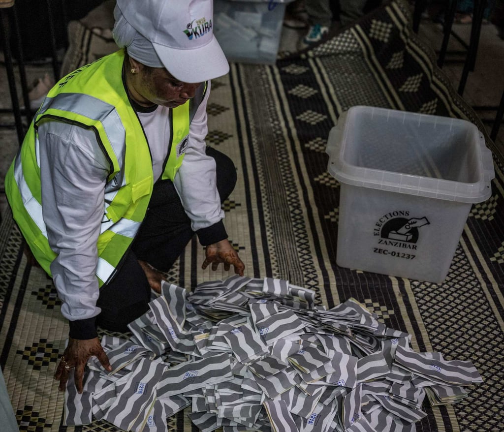 Tanzanian polling station officials spread the ballots at the beginning of the counting operations on Wednesday. Photo: AFP Tanzanian polling station officials spread the ballots at the beginning of the counting operations on Wednesday. Photo: AFP